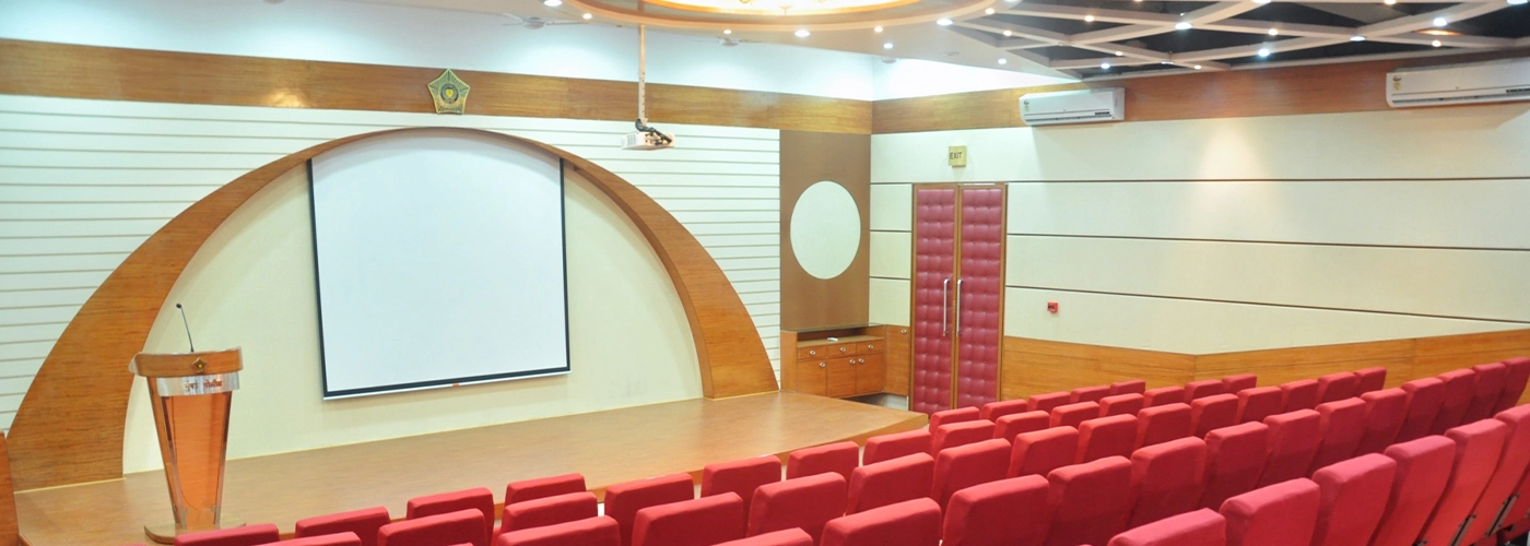 Modern police department auditorium with red seating, wooden stage, and sleek design elements